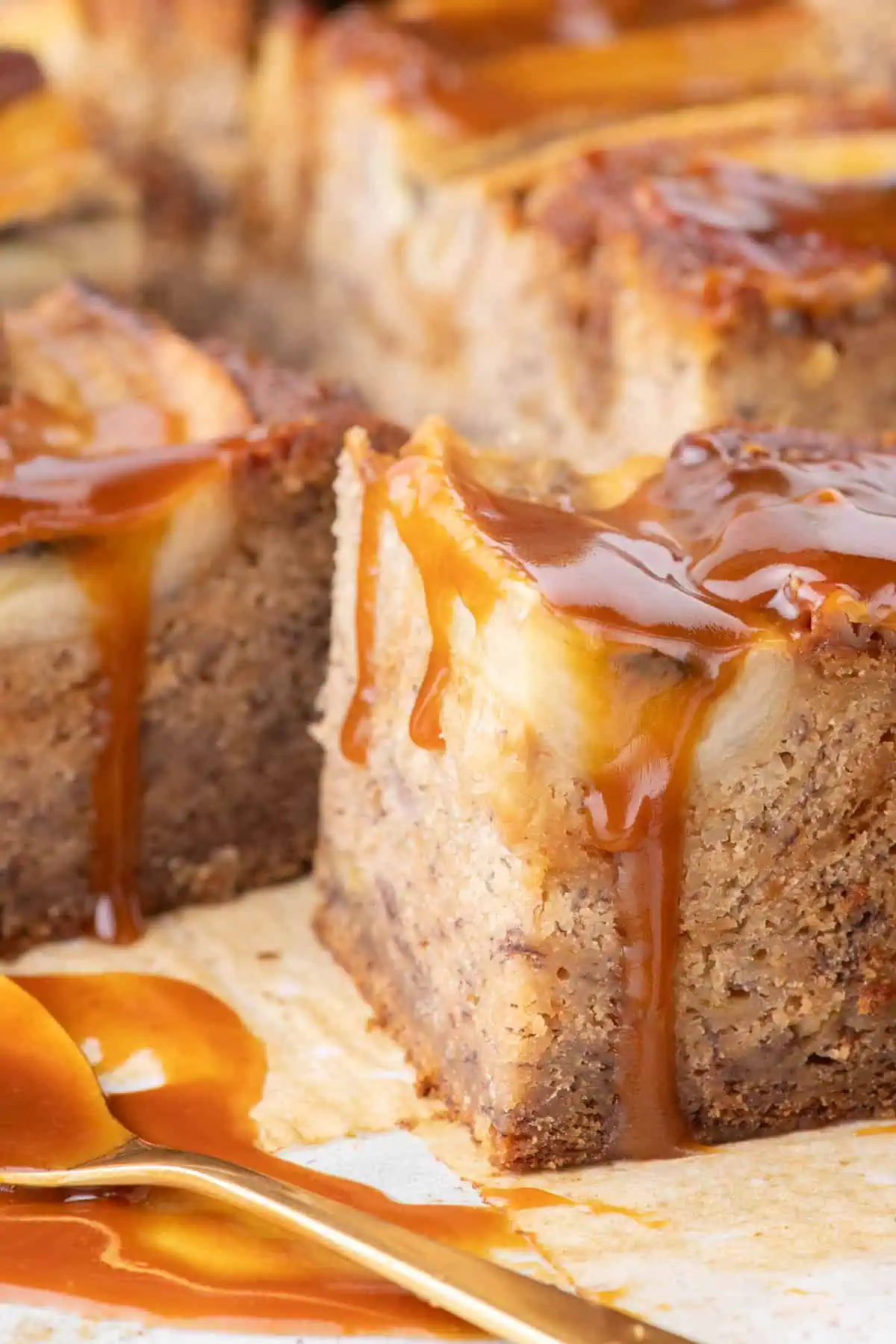 Close-up of cut squares with caramel dripping down the sides.