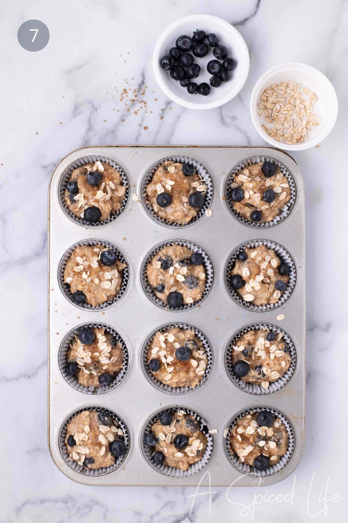 Step 9: Sprinkling muffins with demerara sugar and oats before baking