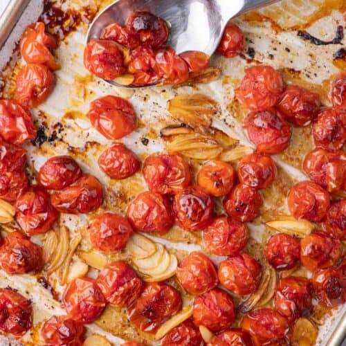 Sheet pan roasted cherry tomatoes with garlic and balsamic—caramelized and jammy with golden edges.
