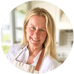 Katrina Poole of A Spiced Life food blog in her kitchen preparing to bake with eggs and milk on the counter.