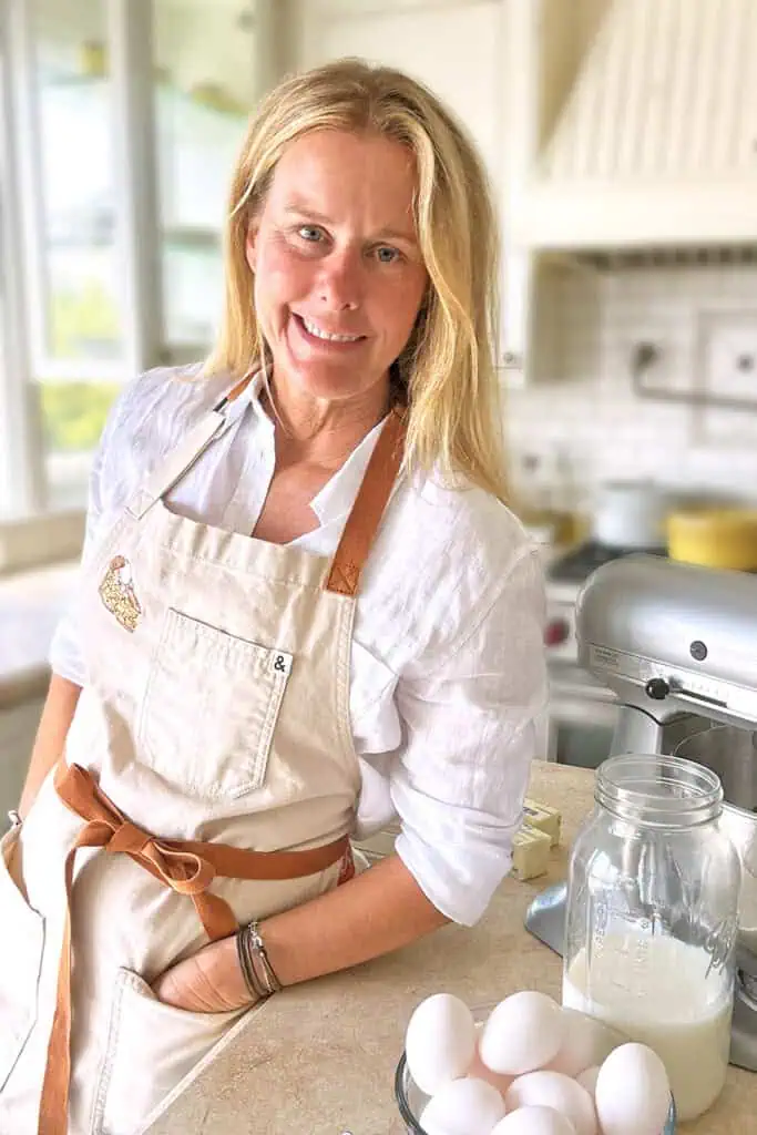 Katrina Poole of A Spiced Life food blog in her kitchen preparing to bake with eggs and milk on the counter.