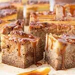 Multiple banana bars on parchment with caramel spoon