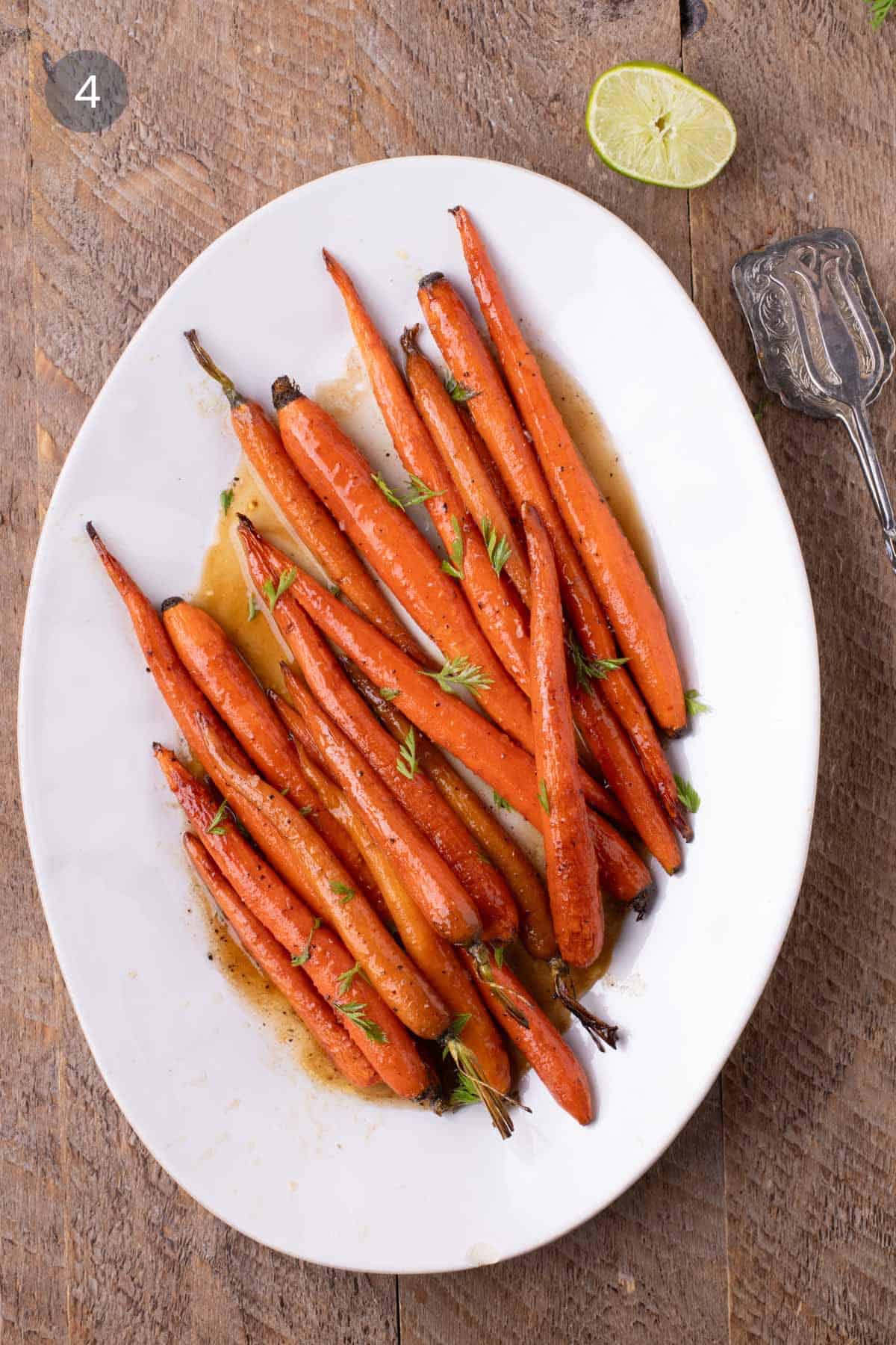 Maple Glazed Carrots topped with chopped carrot greens after roasting