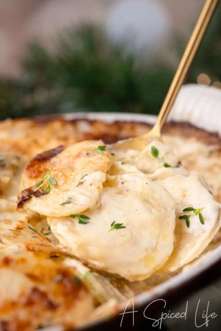 Golden, cheesy potatoes scooped from the baking dish