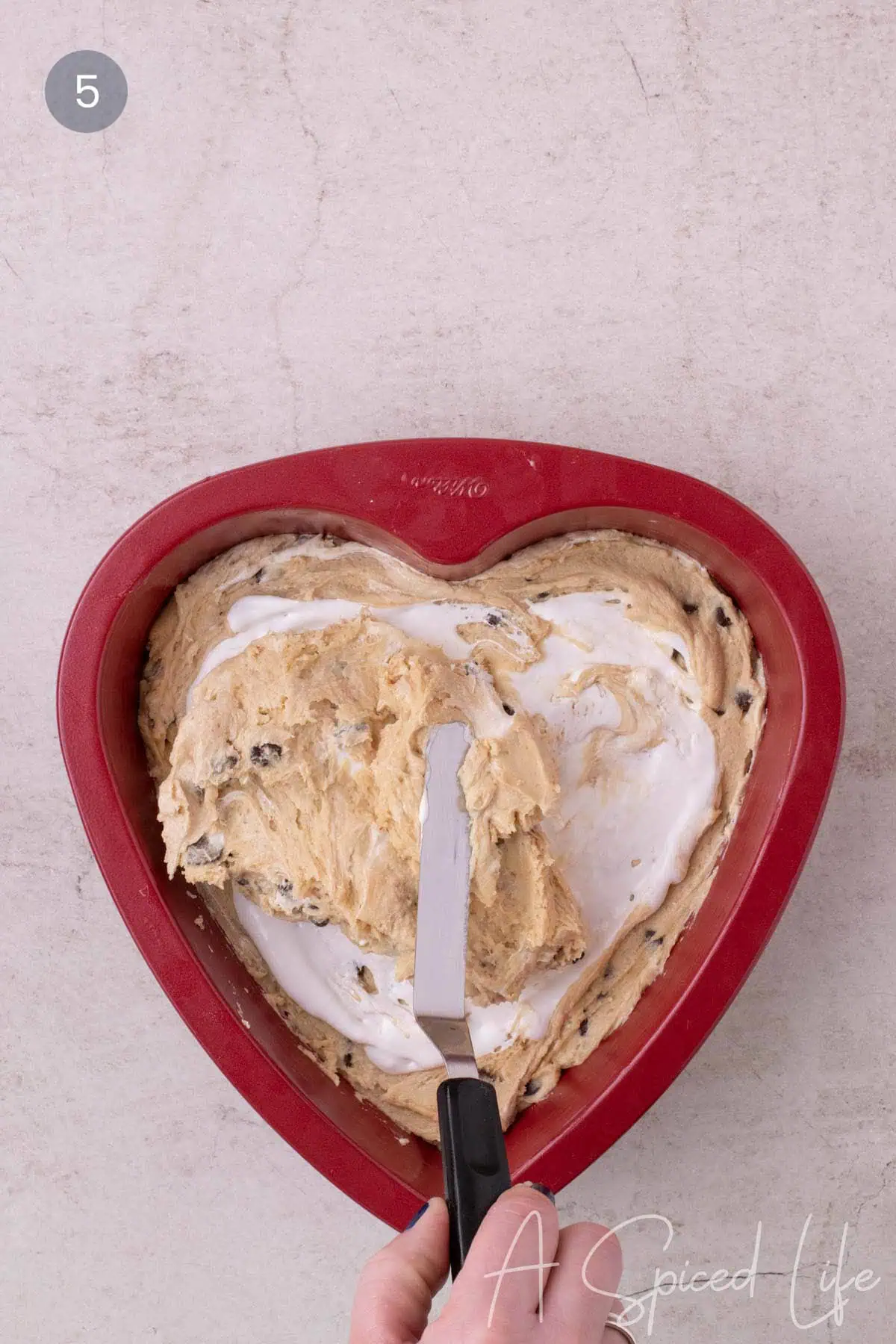 Marshmallow cream swirled into cookie cake batter