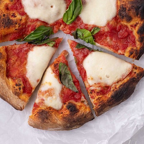 Overhead view of homemade pizza made with store-bought pizza dough and fresh basil