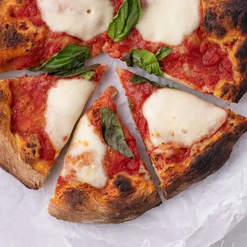 Overhead view of homemade pizza made with store-bought pizza dough and fresh basil