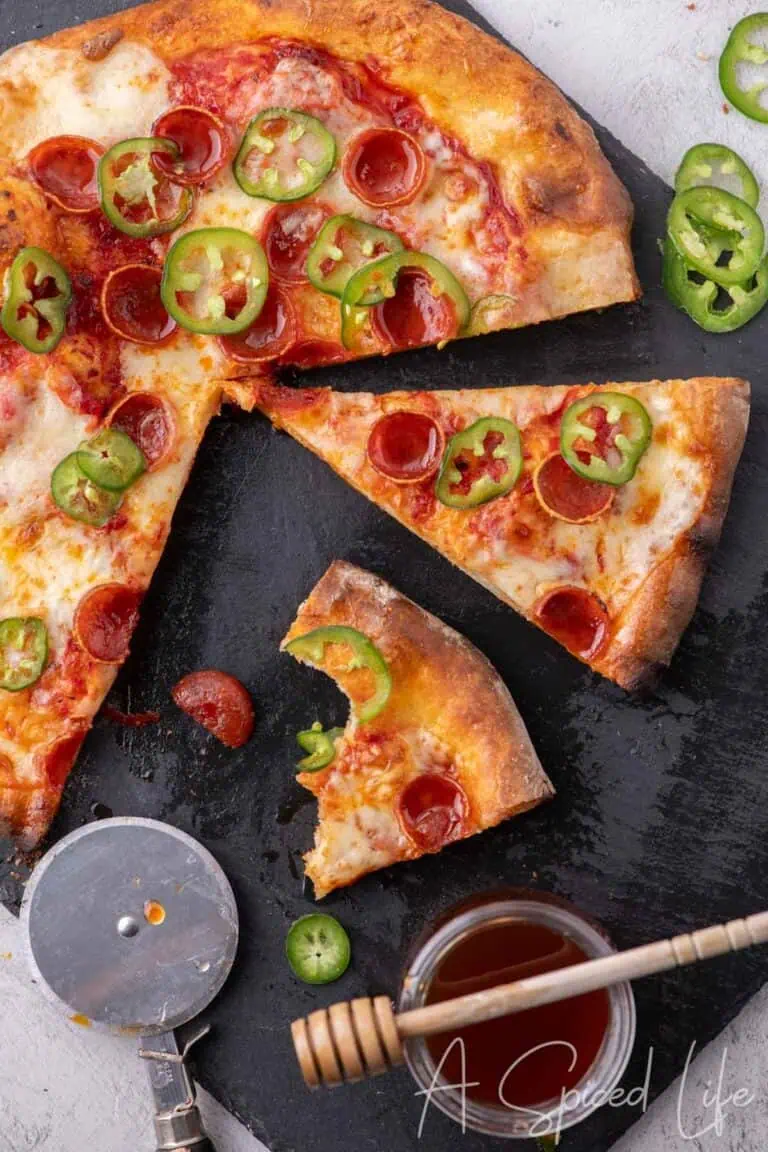 Slices of Diavola pizza topped with pepperoni, jalapeños, and mozzarella.