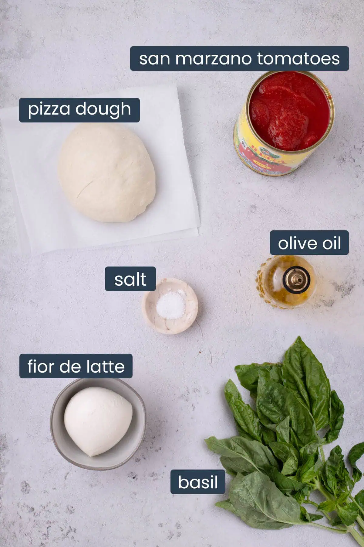 Ingredients for Neapolitan-style pizza including pizza dough, San Marzano tomatoes, olive oil, salt, fior di latte mozzarella, and fresh basil