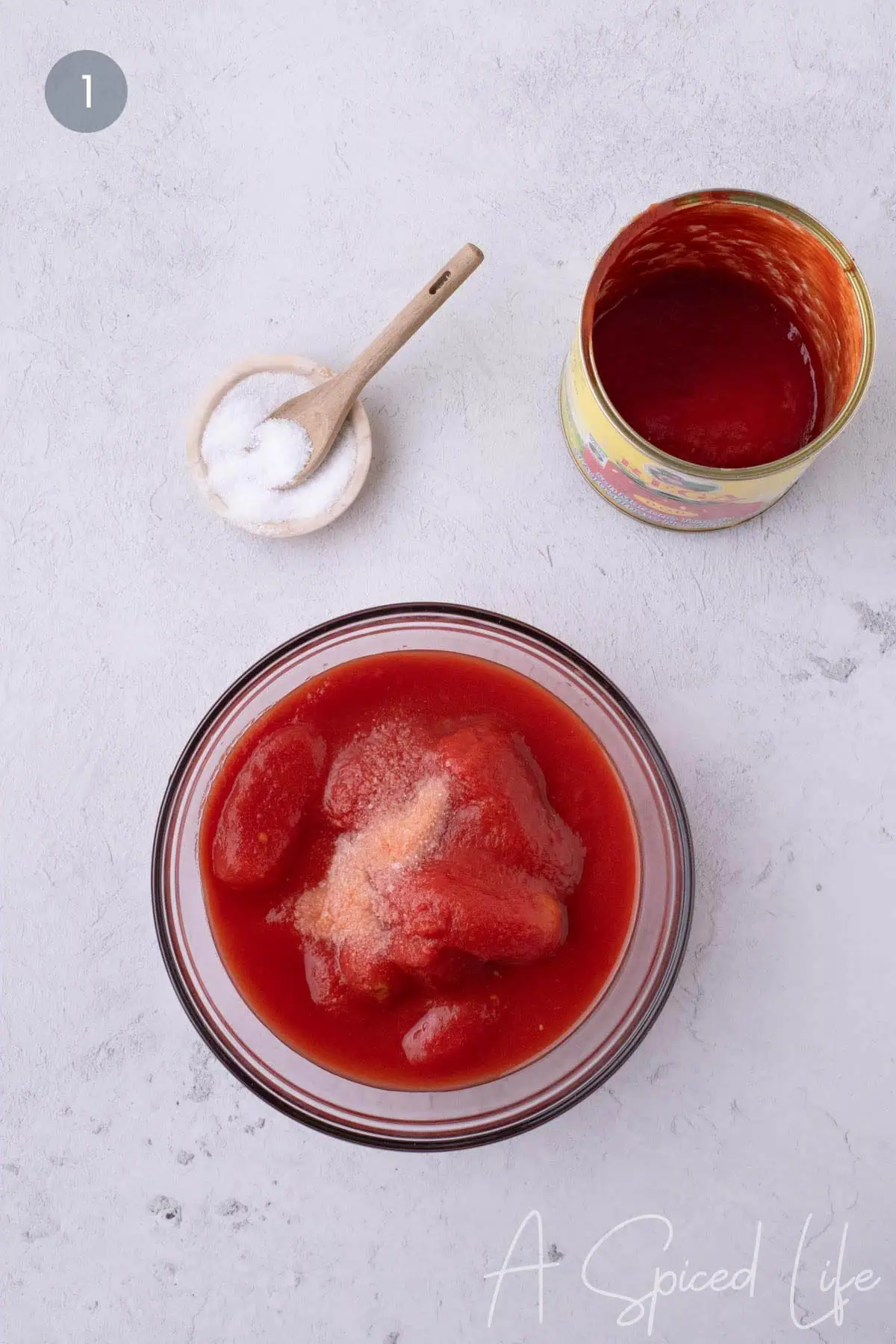 Bowl of whole canned tomatoes with salt to make rustic Neapolitan-style pizza sauce