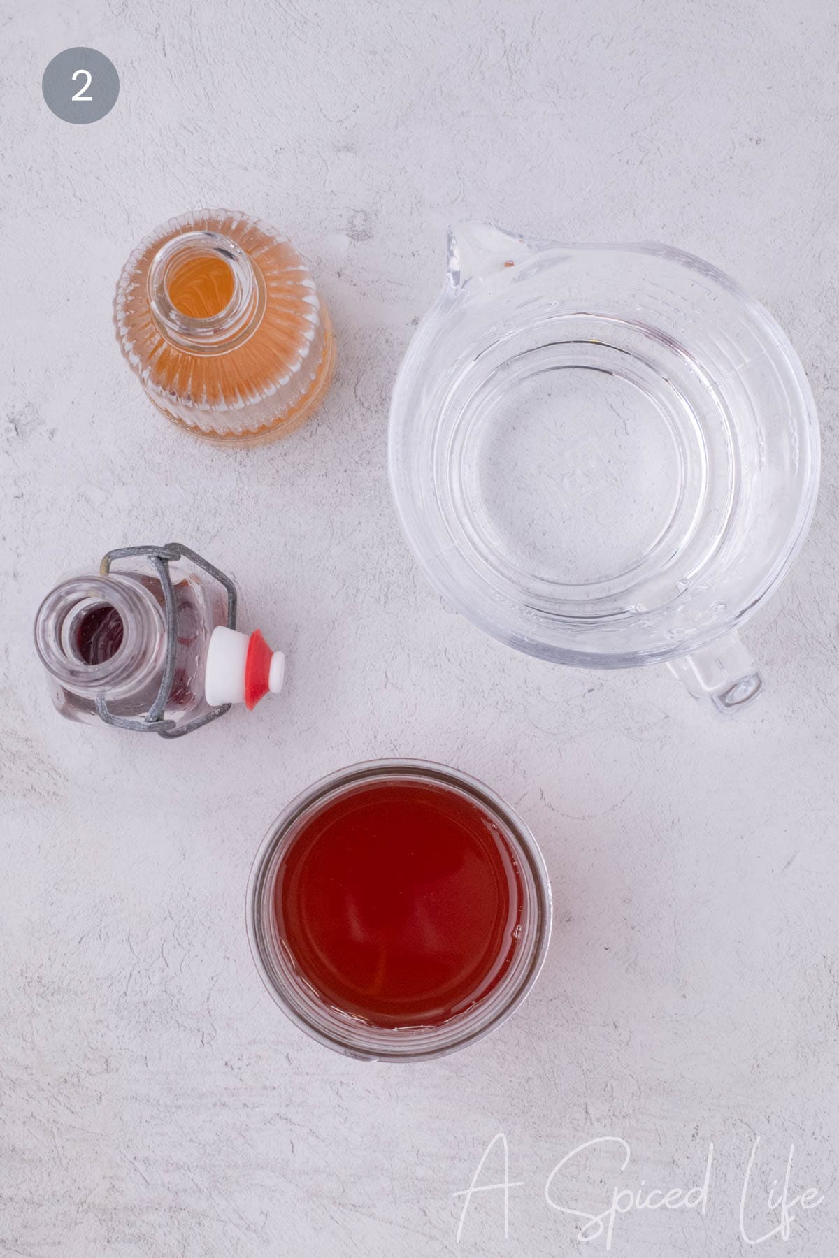 Mixing vinegar and water to create brine for pickled shallots