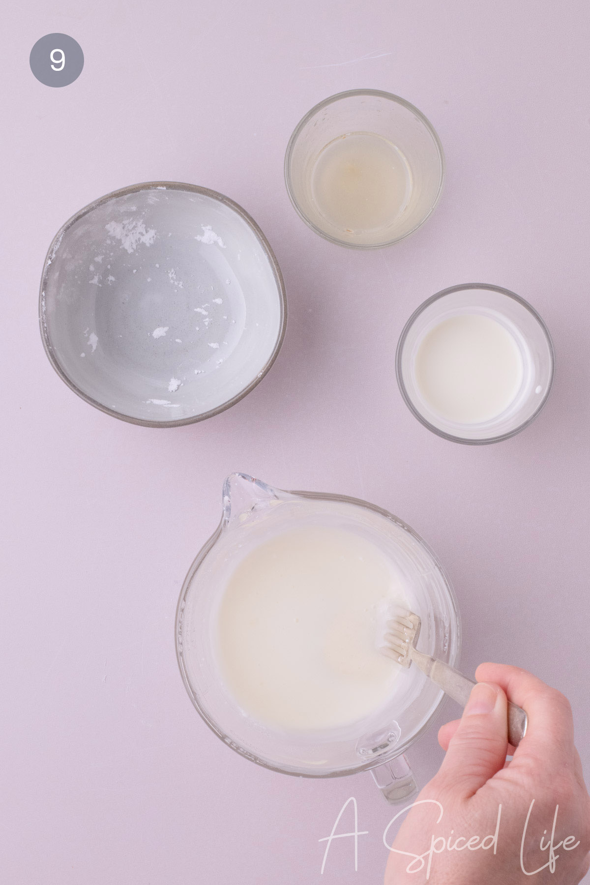 Lemon glaze being whisked in a glass measuring cup