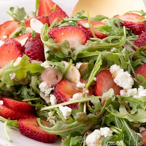 Strawberry and goat cheese salad drizzled with balsamic vinaigrette