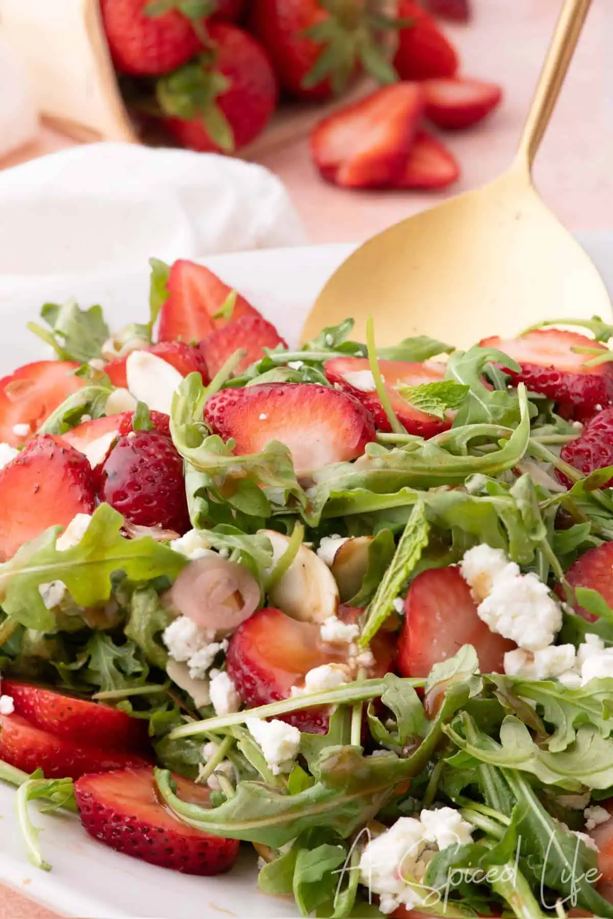 Strawberry and goat cheese salad drizzled with balsamic vinaigrette