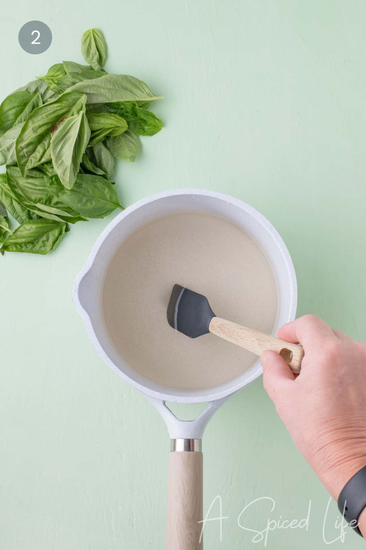 Stirring sugar and water in a saucepan until the mixture becomes clear
