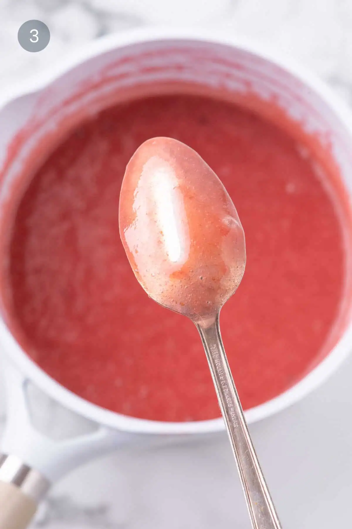 Cooked strawberry purée mixture for berry layered panna cotta.