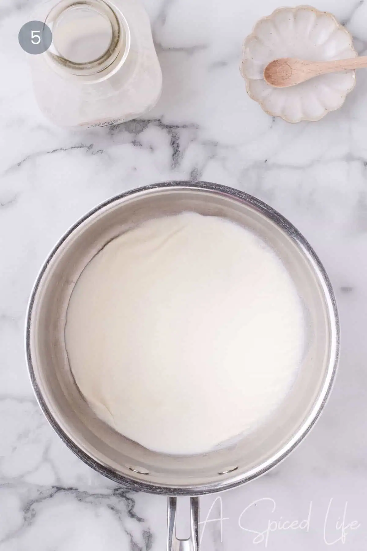 Heavy cream and gelatin blooming for coconut panna cotta.