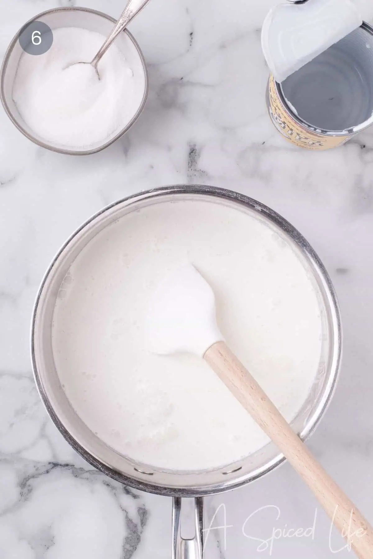 Coconut milk panna cotta mixture heating in saucepan.
