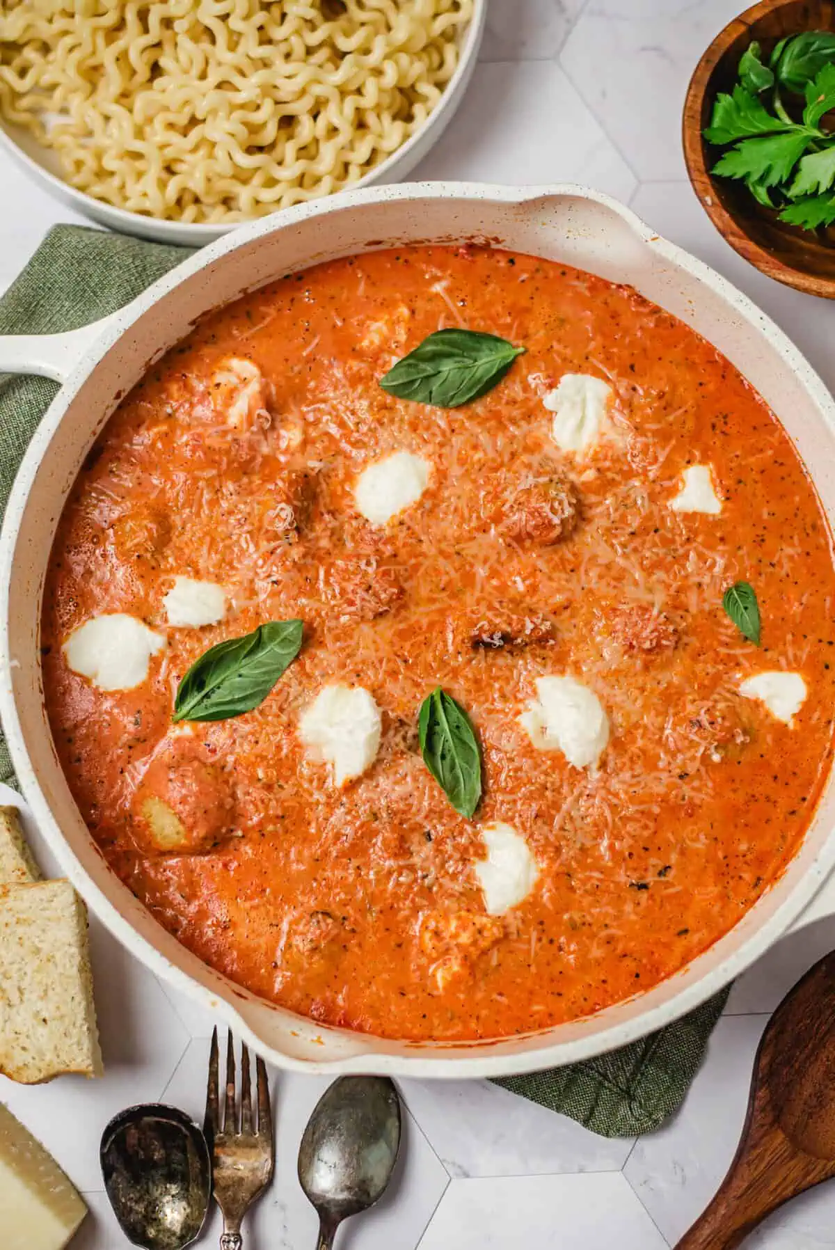 Chicken and ricotta meatballs simmered in creamy fire-roasted tomato sauce topped with basil, Parmesan, and dollops of ricotta.
