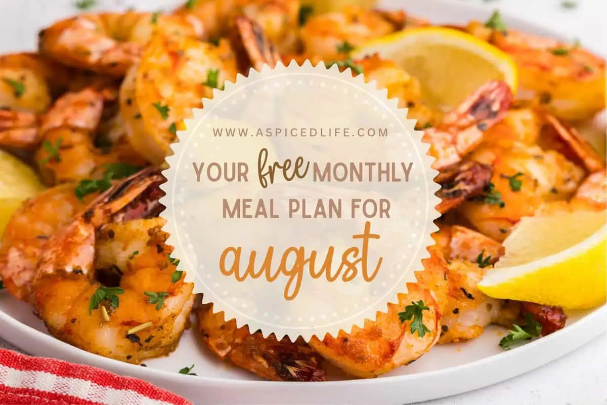 Air fryer shrimp with lemon wedges and fresh parsley promoting the free August monthly meal plan.