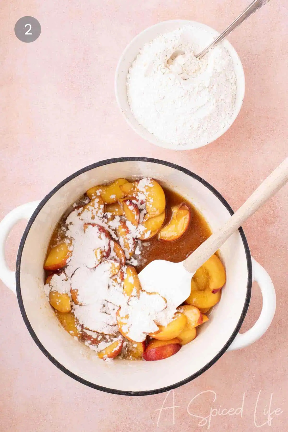 Flour added to the filling for a thick peach and cherry cobbler base.