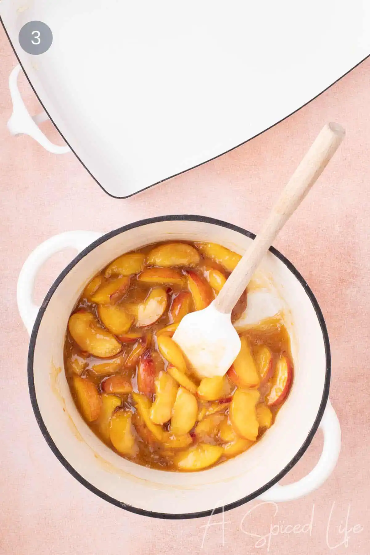 Cooked peach filling in a pot for a juicy fruit cobbler