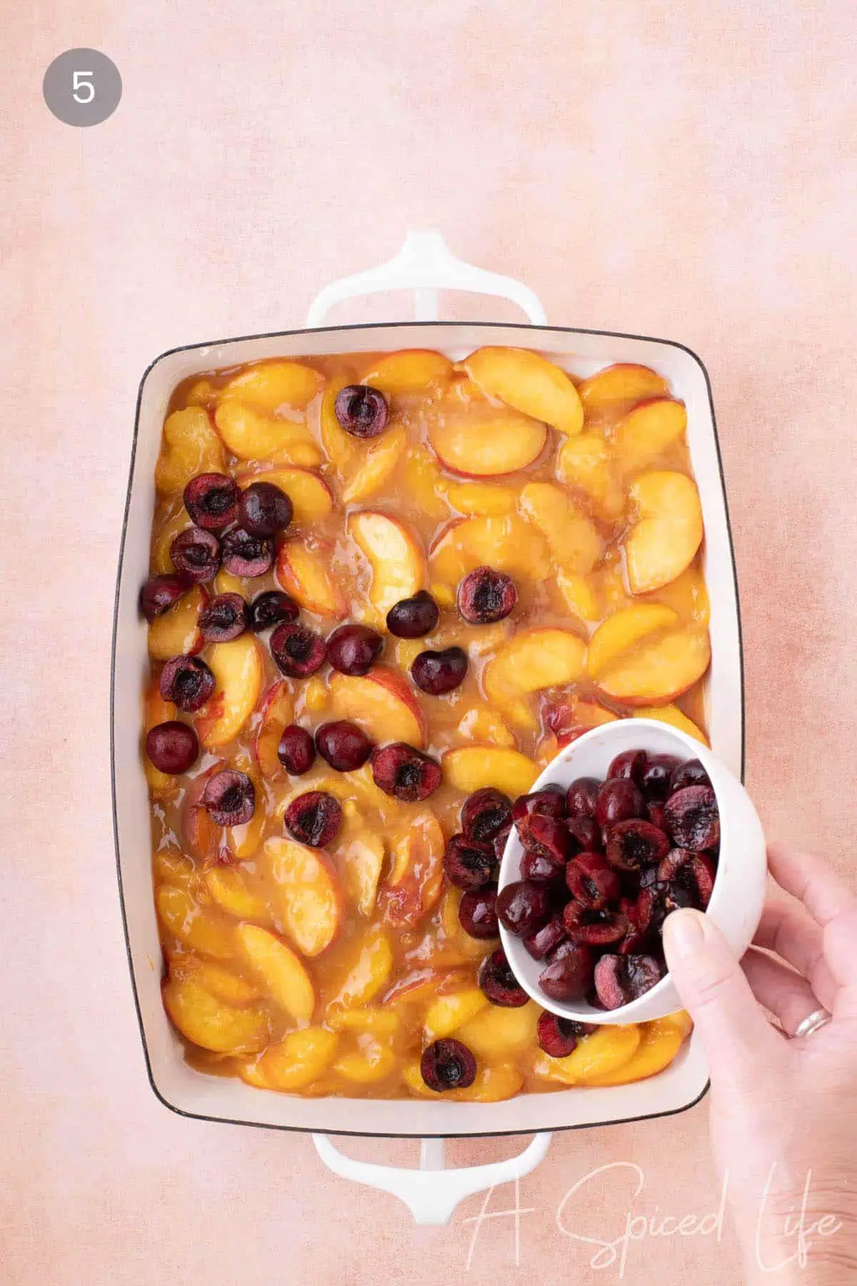 Adding fresh cherries to a summer fruit cobbler
