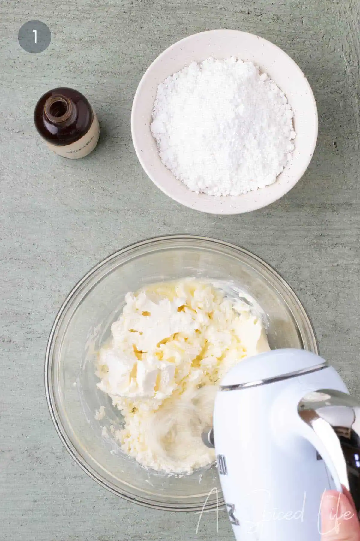 Cream cheese and butter beaten together in a glass mixing bowl for cream cheese glaze.