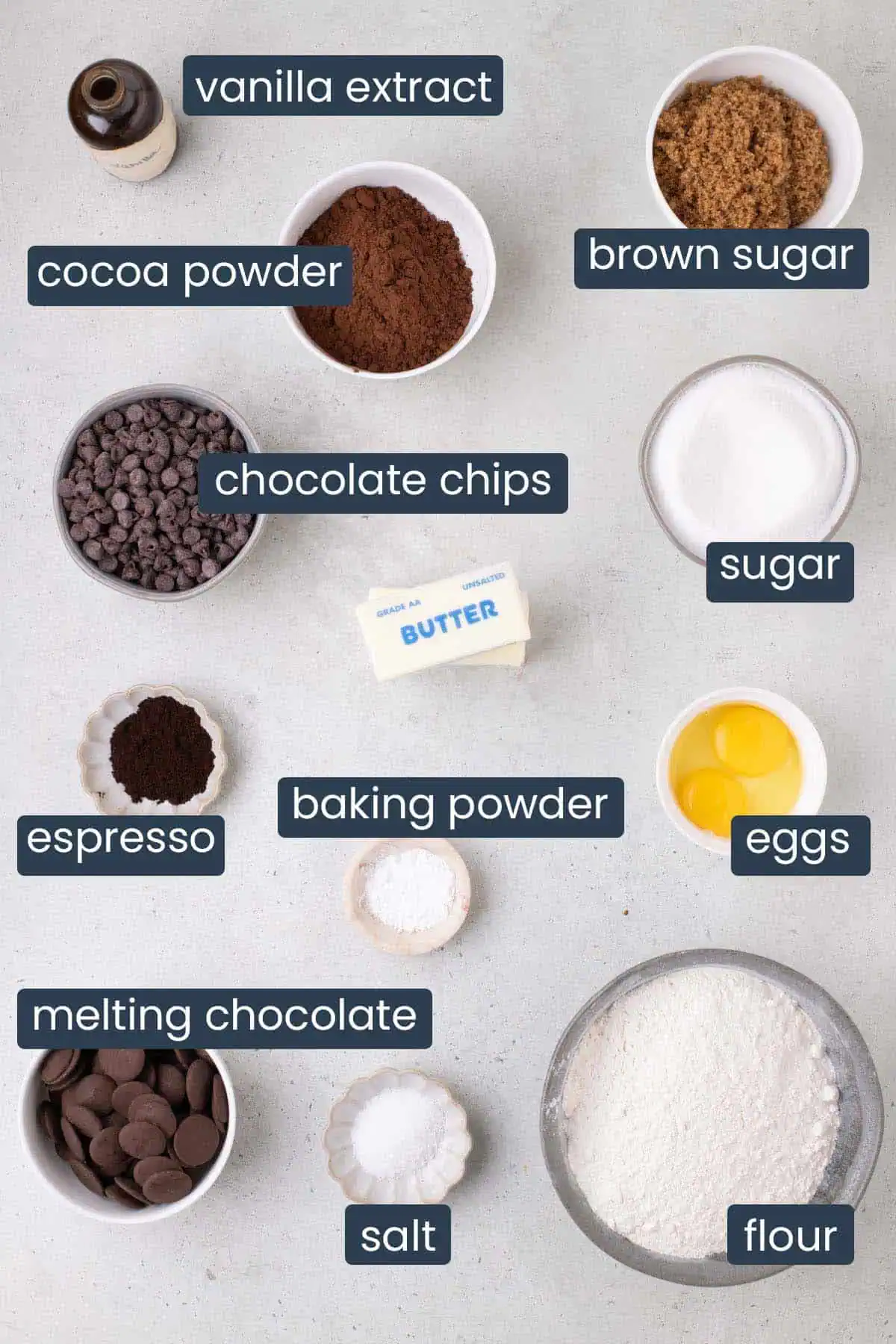 Ingredients for chocolate dipped chocolate cookies including flour, cocoa powder, semisweet chocolate chips, butter, sugars, egg, espresso powder, vanilla, salt, and melting chocolate.
