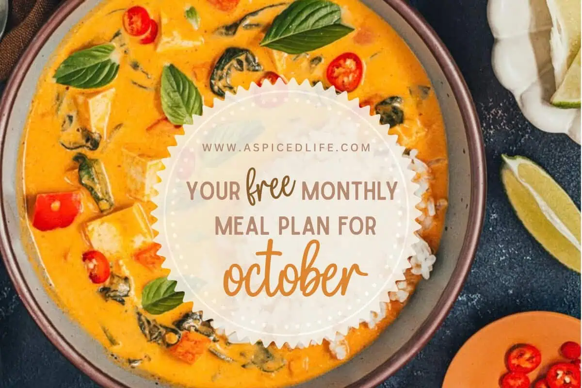 October monthly meal plan graphic over a bowl of pumpkin tofu curry with rice, basil, and red chiles.