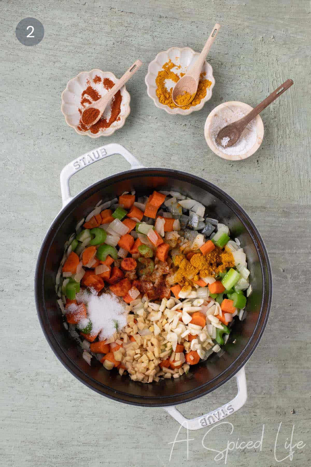 Fresh ginger, garlic, curry powder, cayenne, and salt added to softened vegetables for red lentil stew