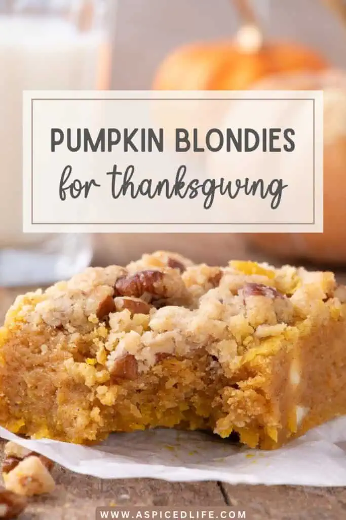 Pinterest pin featuring a bitten pumpkin blondie topped with pecan crumble, with milk and blurred pumpkins in the background and a Thanksgiving text overlay.